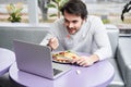 Man having appetite dinner while sitting at the cafe