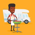 Man having barbecue in front of camper van.