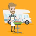 Man having barbecue in front of camper van.