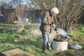 Man having a bonfire at an allotment or community garden vegetable plot to dispose of garden waste Royalty Free Stock Photo