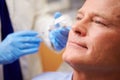 Man Having Botox Treatment At Beauty Clinic