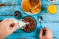 Man having breakfast with cereal chocolate balls