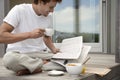 Man Having Breakfast And Reading Newspaper On Porch Royalty Free Stock Photo