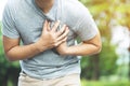 Man having chest pain - heart attack outdoors.