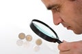 Man having a close look on euro coins Royalty Free Stock Photo