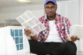 man having difficulty assembling air conditioning unit Royalty Free Stock Photo