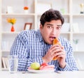 Man having dilemma between healthy food and bread in dieting con Royalty Free Stock Photo