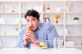 Man having dilemma between healthy food and bread in dieting con Royalty Free Stock Photo