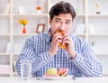 Man having dilemma between healthy food and bread in dieting con Royalty Free Stock Photo