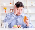 Man having dilemma between healthy food and bread in dieting con Royalty Free Stock Photo