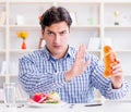 Man having dilemma between healthy food and bread in dieting con Royalty Free Stock Photo