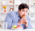 Man having dilemma between healthy food and bread in dieting con Royalty Free Stock Photo