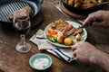 Man is having dinner steak, potatoes, salad with red wine Royalty Free Stock Photo