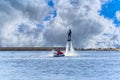 Man having fun on Flyboard. Flyboarding in a sunny summer day at river in harbor. Extrime water activity flyboard.