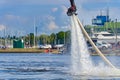 Man having fun on Flyboard. Flyboarding in a sunny summer day at river in harbor. Extrime water activity flyboard.