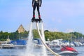 Man having fun on Flyboard. Flyboarding in a sunny summer day at river in harbor. Extrime water activity flyboard.