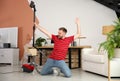 Young man having fun while vacuuming at home Royalty Free Stock Photo