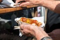 Man having German Currywurst sausage with curry sauce on food market Royalty Free Stock Photo