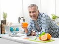 Man having a glass of fresh orange juice Royalty Free Stock Photo