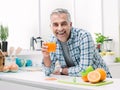 Man having a glass of fresh orange juice Royalty Free Stock Photo