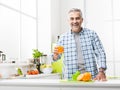 Man having a glass of fresh orange juice Royalty Free Stock Photo