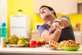 The man having hard choice between healthy and unhealthy food Royalty Free Stock Photo