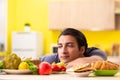 The man having hard choice between healthy and unhealthy food Royalty Free Stock Photo