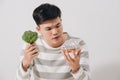 Man having hard choice between healthy and unhealthy food Royalty Free Stock Photo