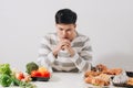 Man having hard choice between healthy and unhealthy food Royalty Free Stock Photo