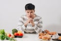 Man having hard choice between healthy and unhealthy food Royalty Free Stock Photo