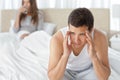 Man having a headache sitting on the bed Royalty Free Stock Photo