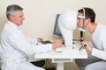 Man having his eyes examined by an eye elderly Royalty Free Stock Photo