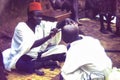 A man having his head shaved outdoors in Yendi, Ghana c.1959