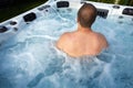 Man having massage in hot tub spa. Royalty Free Stock Photo