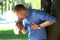 Man having panic attack outdoors Royalty Free Stock Photo