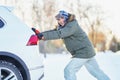 Man having problem with car during snowy winter Royalty Free Stock Photo