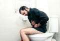 Man having problems in toilet Royalty Free Stock Photo