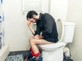 Man having problems in toilet Royalty Free Stock Photo