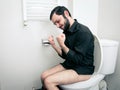 Man having problems in toilet Royalty Free Stock Photo