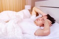 Man having sleepless on bed and having migraine,stress, insomnia Royalty Free Stock Photo