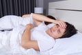 Man having sleepless on bed and having migraine,stress, insomnia Royalty Free Stock Photo