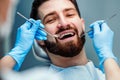 Man having teeth examined at dentists. Close up view