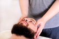 Man having treatment for his face at massage table