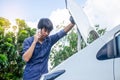 Man having trouble with his broken car and checking on a car engine and talking phone with someone about car for help Royalty Free Stock Photo