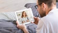 Man Having Video Call With Doctor On Digital Tablet While Lying In Bed Royalty Free Stock Photo