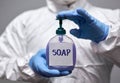 Man in hazmat holding soap dispenser Royalty Free Stock Photo