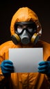 Man in hazmat suit holding sign, ready for personalized message or caution.