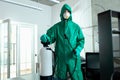 Responsible specialist demonstrating portable disinfectant tank stock photo