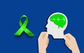 Man Head With green Brain sign and Awareness Ribbon symbol on blue background, World Mental health concept Royalty Free Stock Photo