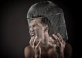 Man with the head inside a birdcage